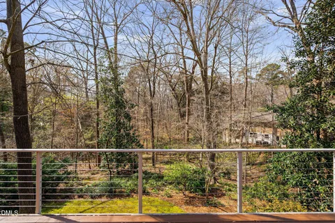 a view of a balcony with a small yard