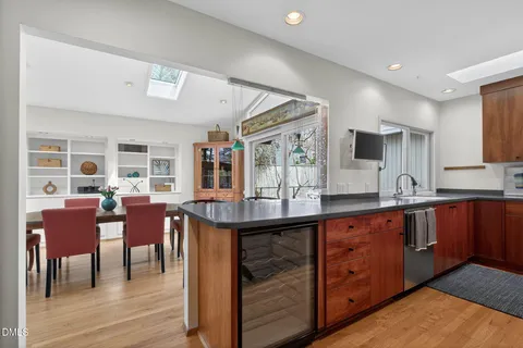 a kitchen with stainless steel appliances a sink stove and cabinets