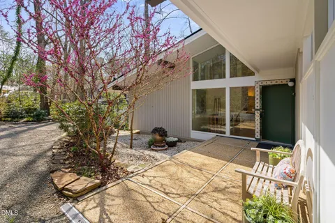 a backyard of a house with table and chairs