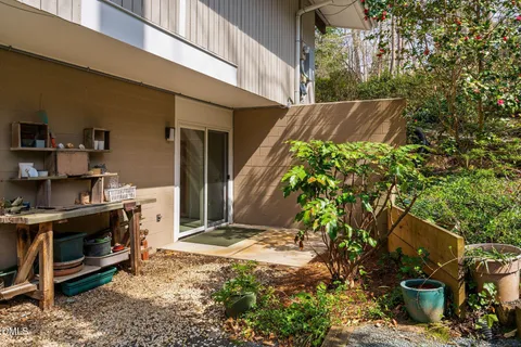 a living room with stainless steel appliances furniture a dining table and a wooden floor