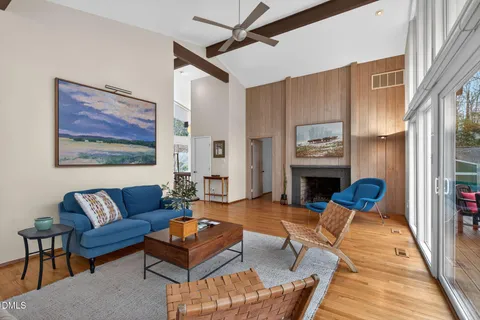 a living room with furniture a rug and a fireplace