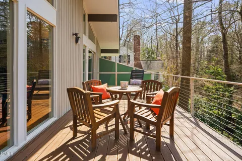 a view of a chairs and table in the balcony