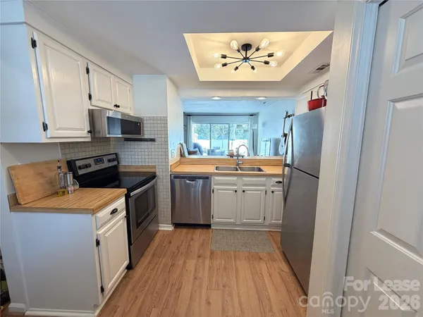 a kitchen with a sink and a stove top oven