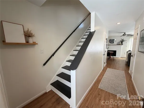 a view of entryway and hall with wooden floor