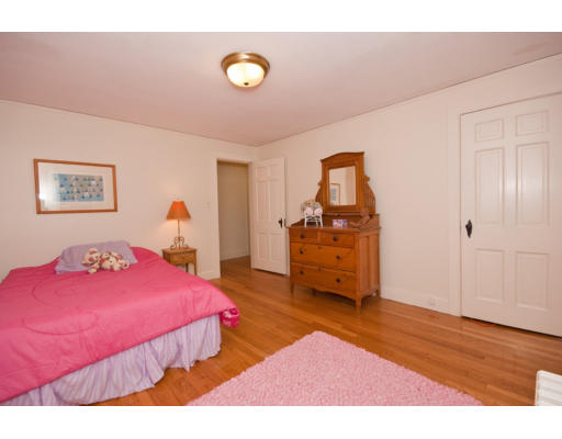14 Robbins Road Lexington, MA 02421 - Photo 20 of 27 a bedroom with a bed and wooden floor