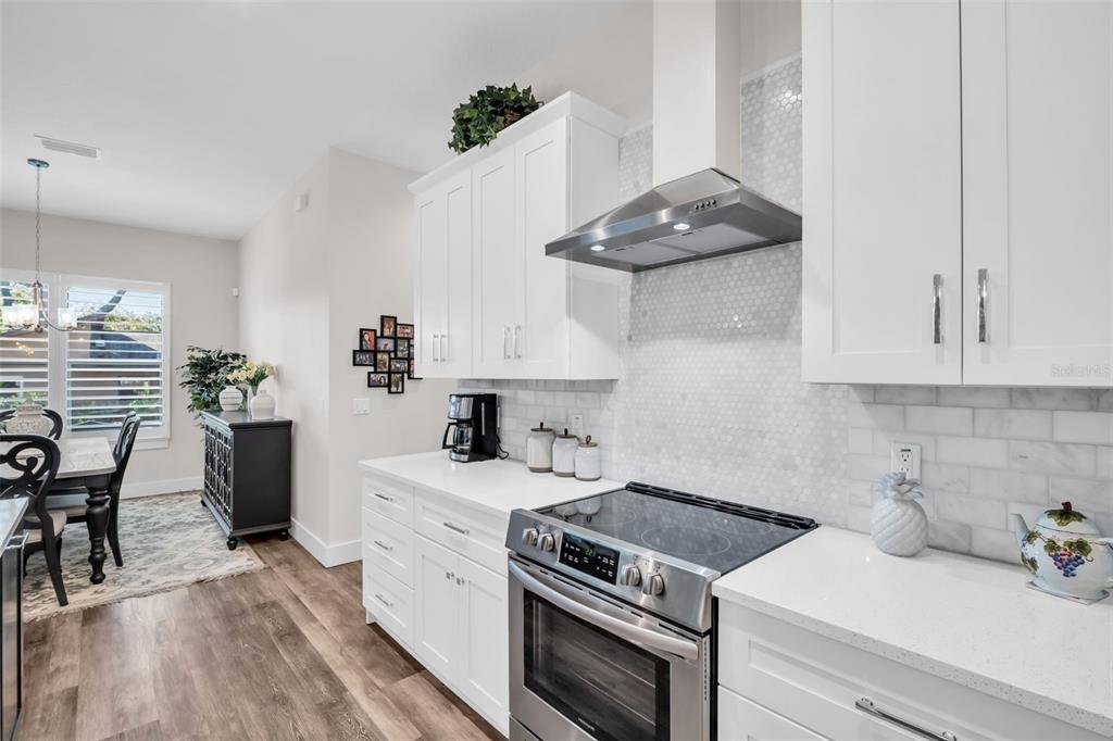 9840 West Bay Street Seminole, FL 33776 - Photo 14 of 75 a kitchen with stainless steel appliances a stove a sink and cabinets