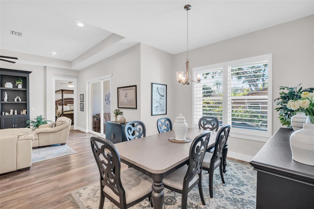 9840 West Bay Street Seminole, FL 33776 - Photo 17 of 75 a view of a dining room with furniture window and wooden floor