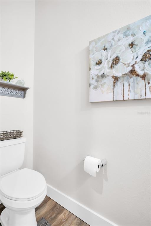 9840 West Bay Street Seminole, FL 33776 - Photo 23 of 75 a white toilet sitting next to a bathroom sink