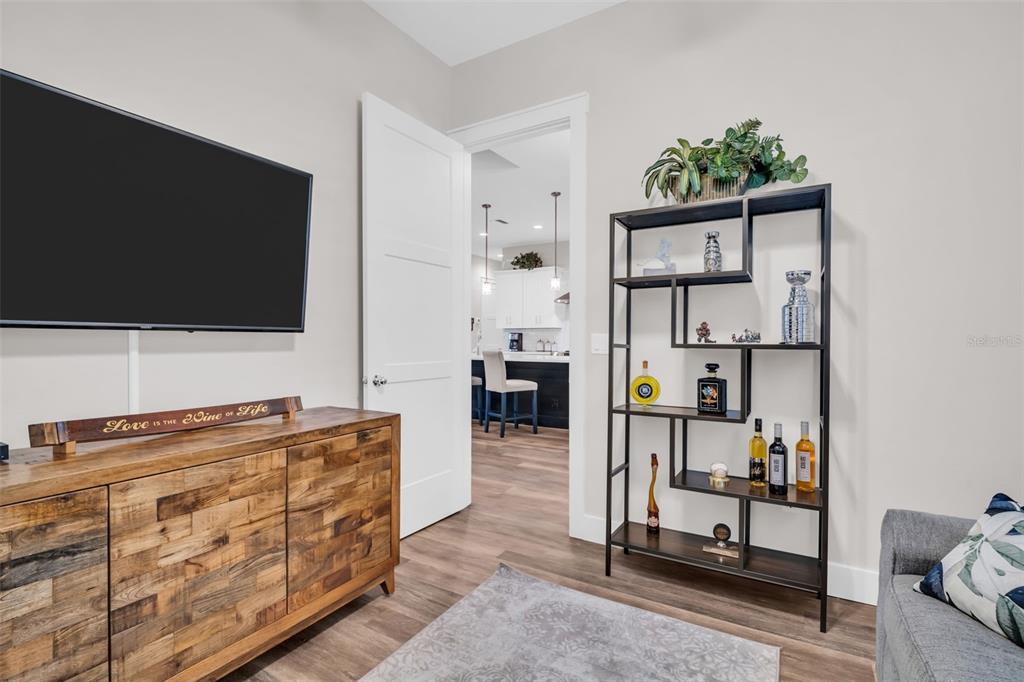 9840 West Bay Street Seminole, FL 33776 - Photo 26 of 75 a living room with furniture and a flat screen tv