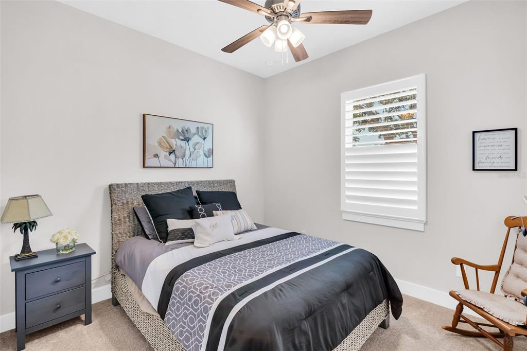 9840 West Bay Street Seminole, FL 33776 - Photo 33 of 75 a bedroom with a bed and a chandelier