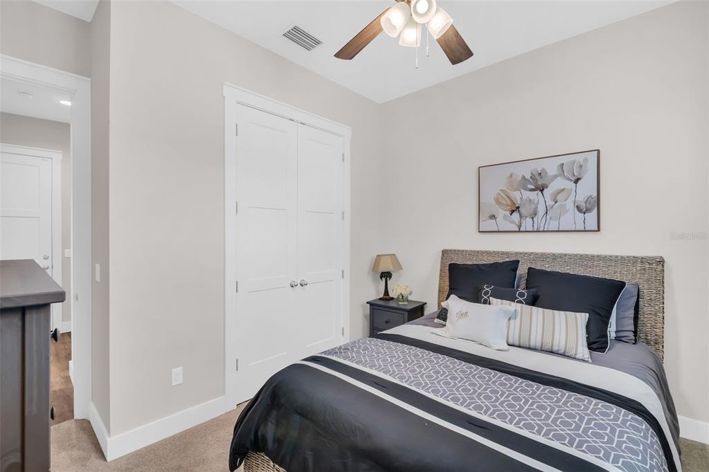 9840 West Bay Street Seminole, FL 33776 - Photo 34 of 75 a bedroom with a large bed and a chandelier