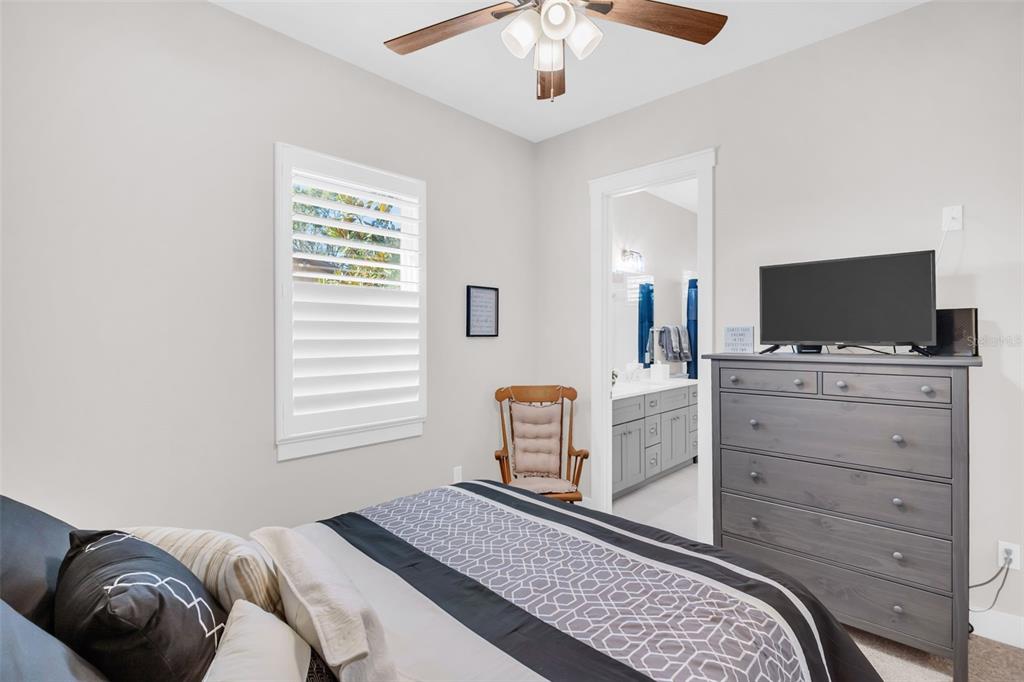 9840 West Bay Street Seminole, FL 33776 - Photo 36 of 75 a bedroom with a bed and flat screen tv