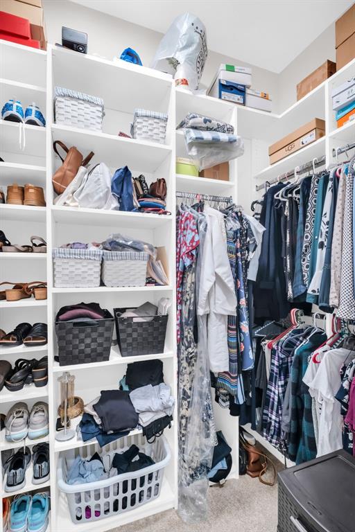 9840 West Bay Street Seminole, FL 33776 - Photo 42 of 75 a view of walk in closet with clothes and shoes