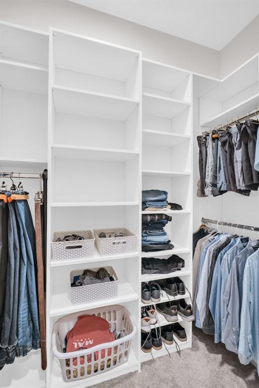 9840 West Bay Street Seminole, FL 33776 - Photo 43 of 75 a view of walk in closet with clothes and shoes