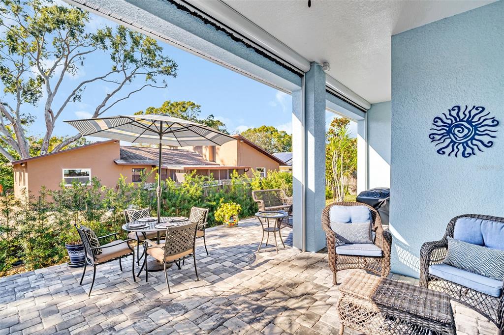 9840 West Bay Street Seminole, FL 33776 - Photo 50 of 75 a view of a patio with a table and chairs and potted plants