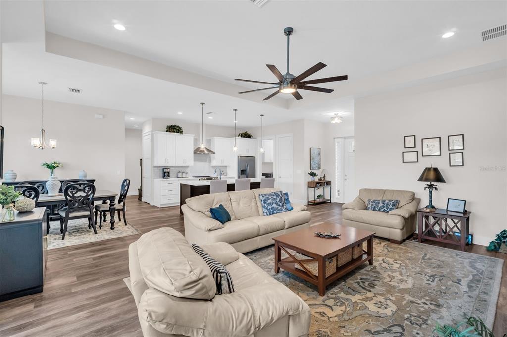 9840 West Bay Street Seminole, FL 33776 - Photo 5 of 75 a living room with furniture kitchen view and a wooden floor