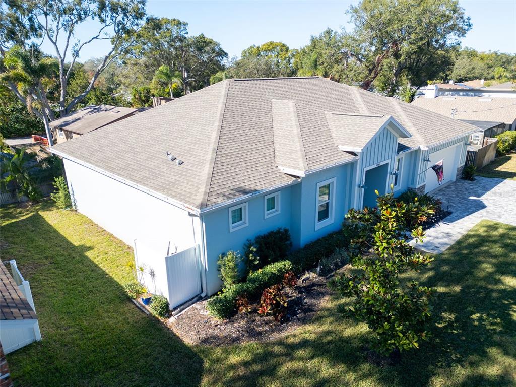 9840 West Bay Street Seminole, FL 33776 - Photo 56 of 75 a aerial view of a house with a yard and a garage