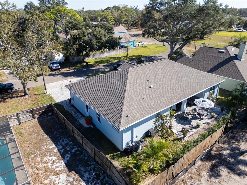 9840 West Bay Street Seminole, FL 33776 - Photo 57 of 75 a view of a swimming pool with a patio and a yard