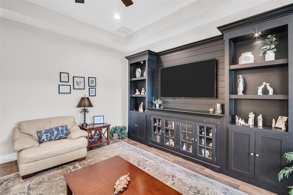 9840 West Bay Street Seminole, FL 33776 - Photo 7 of 75 a living room with furniture and a flat screen tv