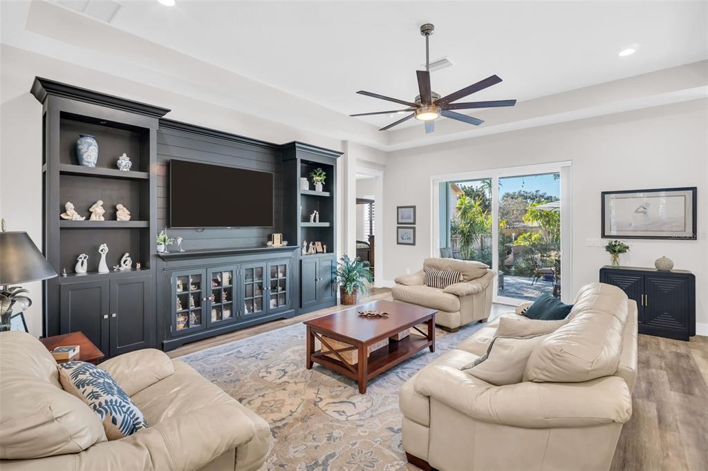 9840 West Bay Street Seminole, FL 33776 - Photo 8 of 75 a living room with furniture and a flat screen tv