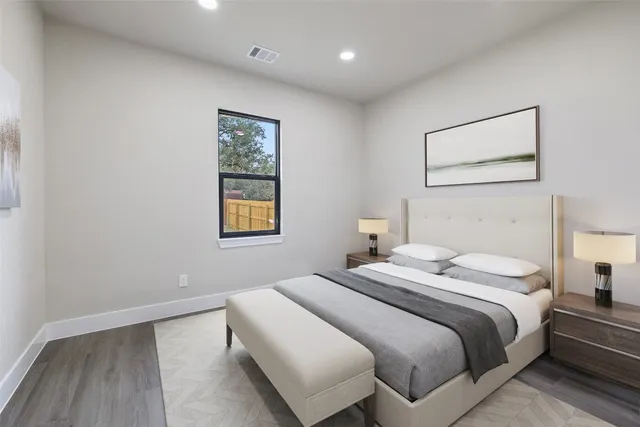 a bedroom with a bed and a night stand