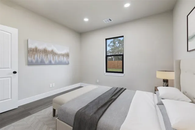 a bedroom with a bed and a painting