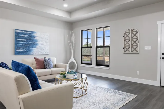 a living room with furniture and wooden floor