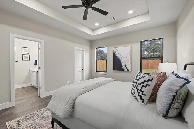 a bedroom with a large bed and a chandelier