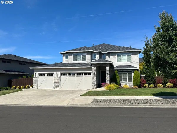 a front view of a house with a yard and garage