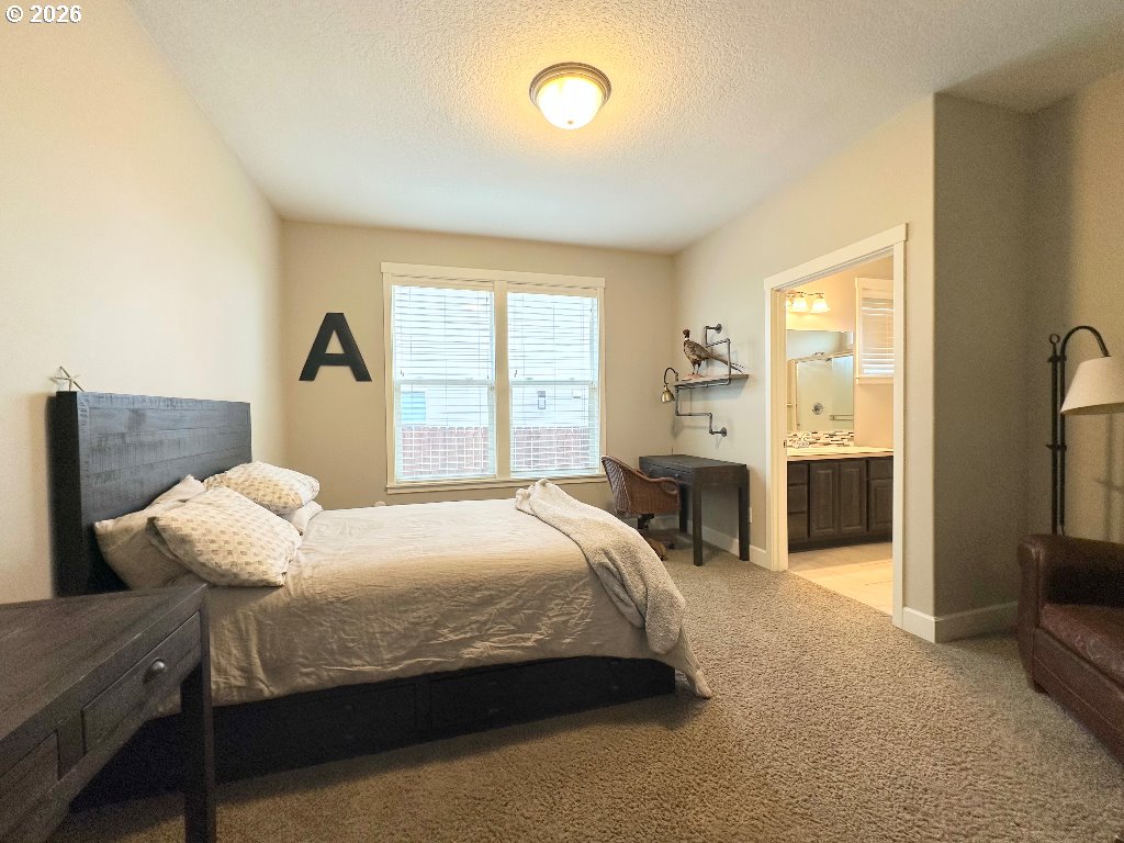885 North Squire Drive Ridgefield, WA 98642 - Photo 16 of 29 a bedroom with a bed and a large window