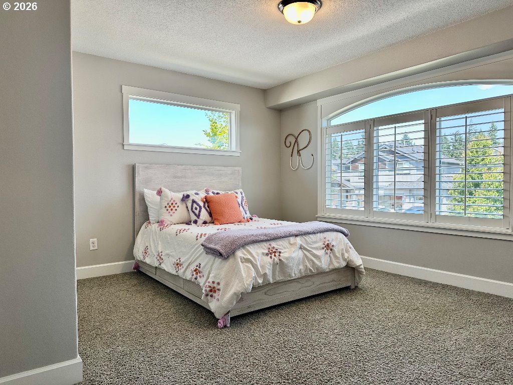 885 North Squire Drive Ridgefield, WA 98642 - Photo 18 of 29 a bed sitting in a bedroom next to a window