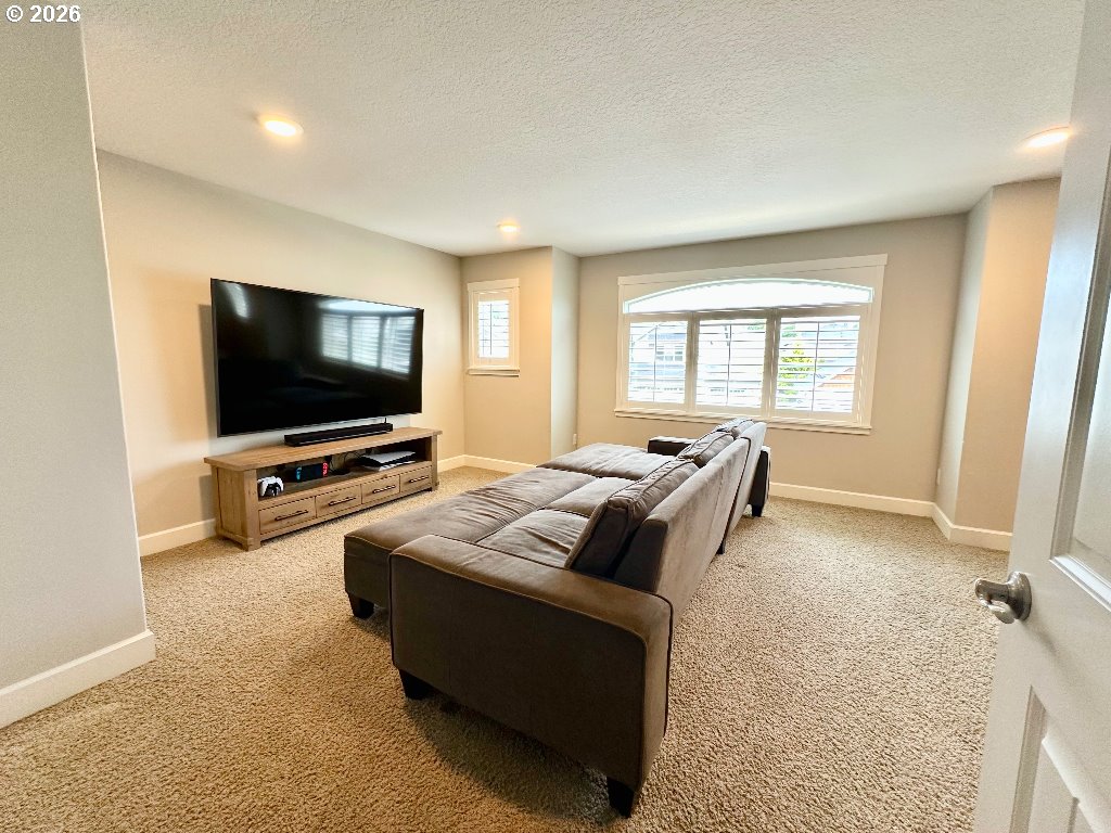 885 North Squire Drive Ridgefield, WA 98642 - Photo 21 of 29 a living room with furniture and a flat screen tv