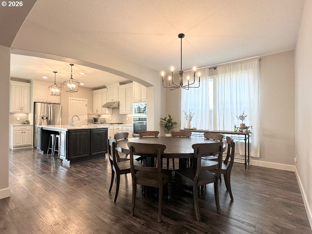 885 North Squire Drive Ridgefield, WA 98642 - Photo 3 of 29 a view of a dining room and livingroom with furniture wooden floor a rug a chandelier