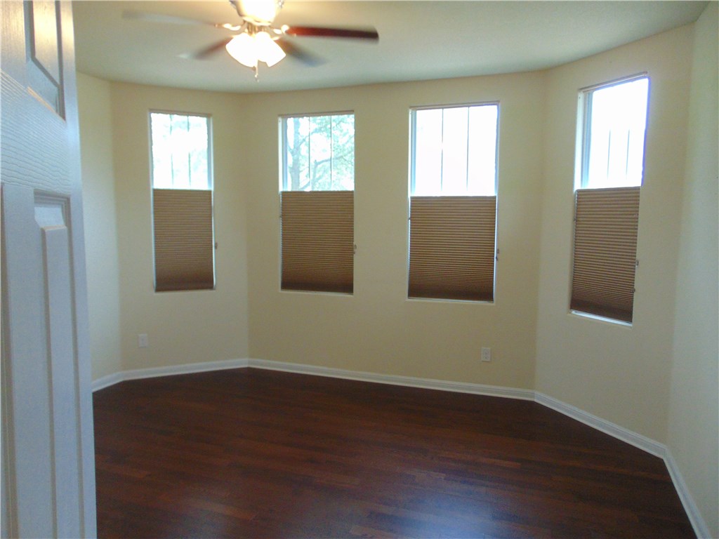 5208 Hellman Kyle, TX 78640 - Photo 14 of 26 a view of an empty room with wooden floor and a window
