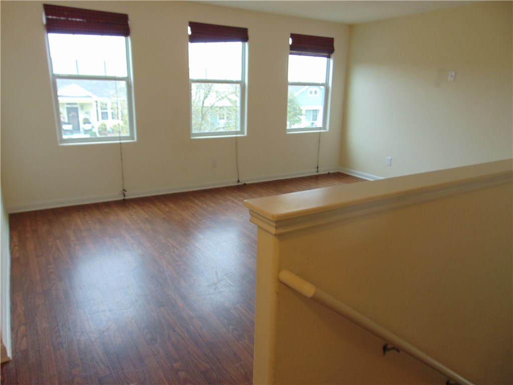 5208 Hellman Kyle, TX 78640 - Photo 20 of 26 an empty room with wooden floor and windows