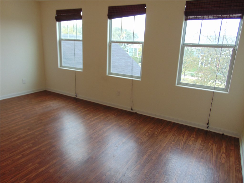 5208 Hellman Kyle, TX 78640 - Photo 21 of 26 an empty room with wooden floor and windows