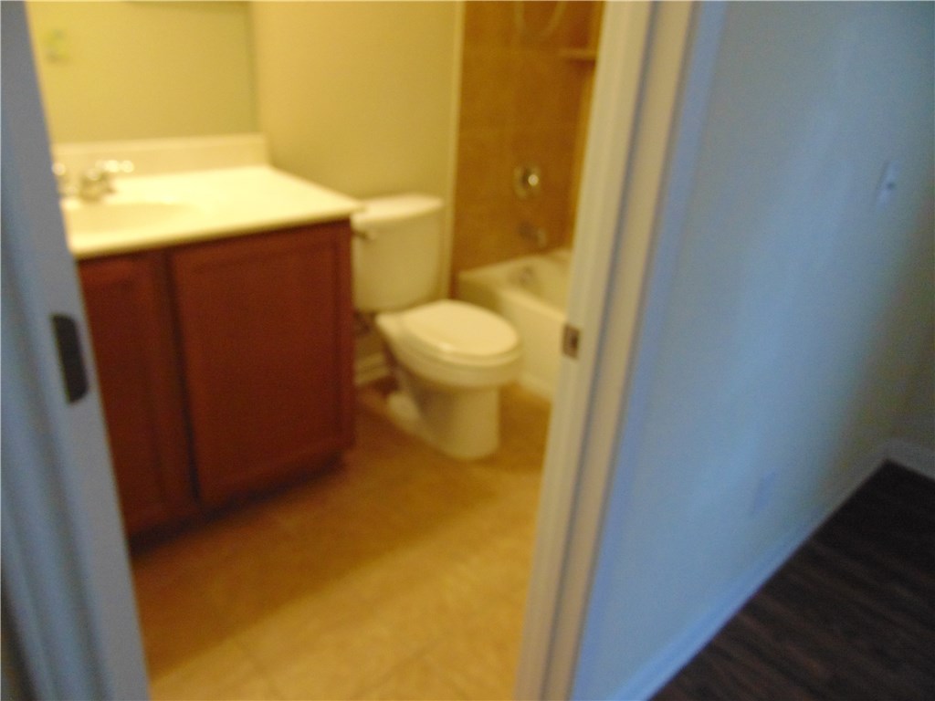 5208 Hellman Kyle, TX 78640 - Photo 22 of 26 a bathroom with a toilet and a sink