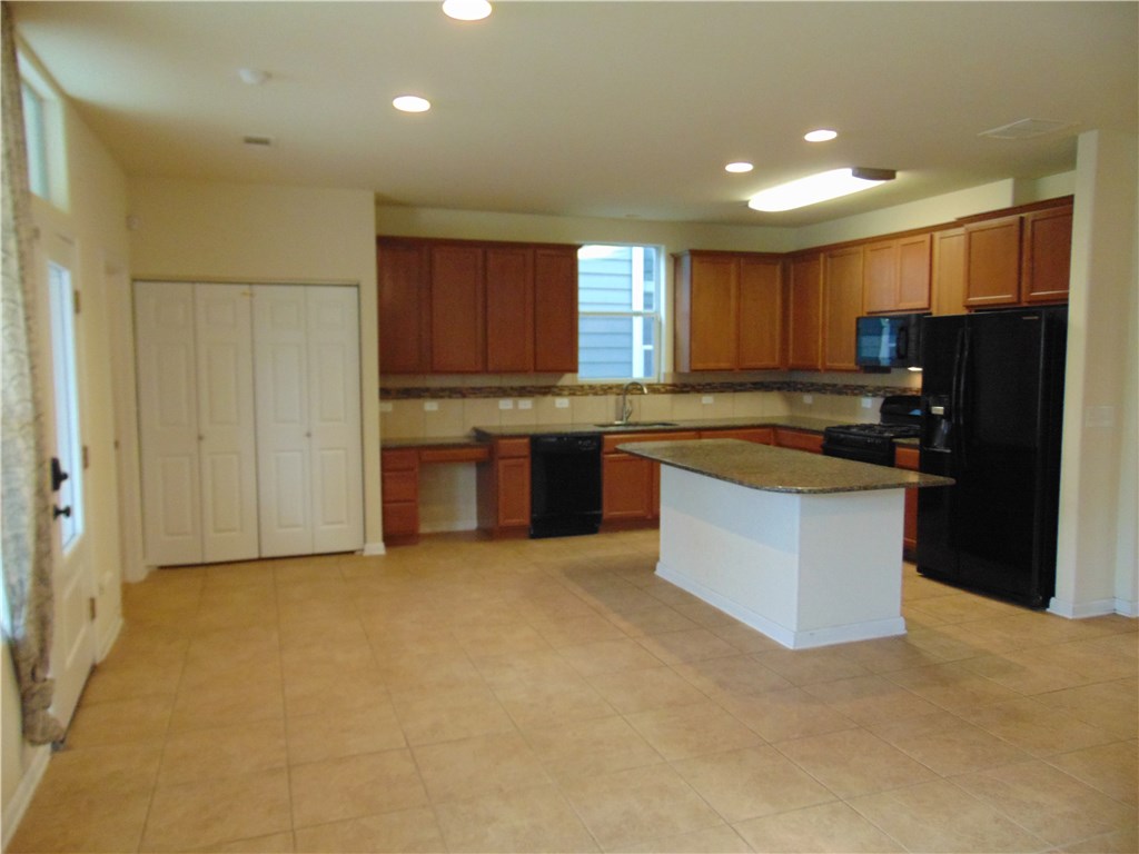 5208 Hellman Kyle, TX 78640 - Photo 6 of 26 a kitchen with stainless steel appliances granite countertop a refrigerator and a sink