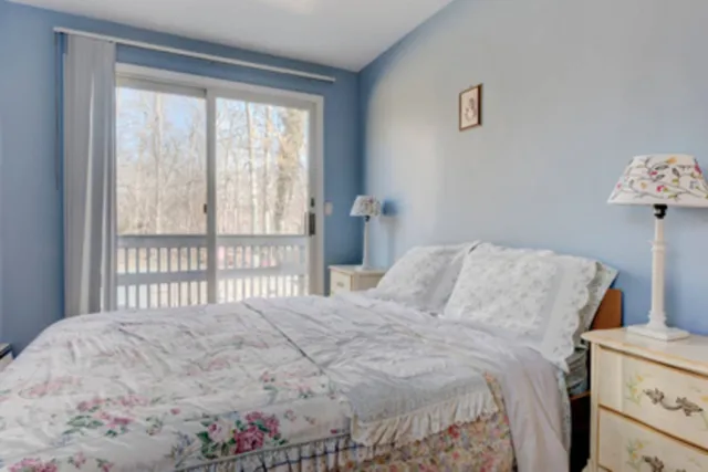a bedroom with a bed and a large window