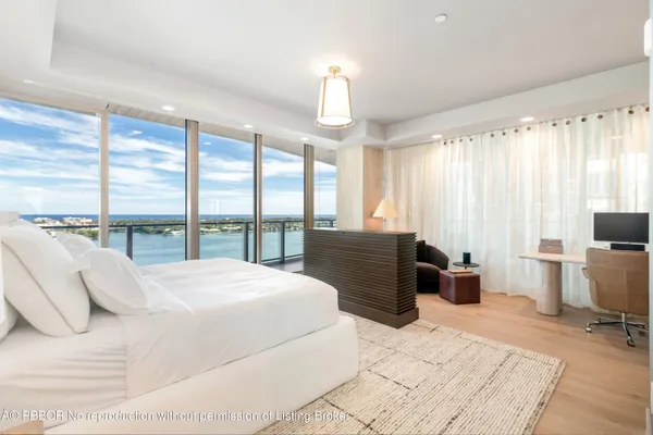 a bedroom with a large bed and a couch