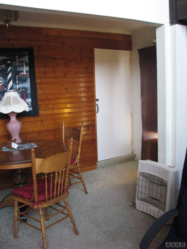 424 Beech Bay Road Roper, NC 27970 - Photo 30 of 35 Dining area with paneling and door to stairs