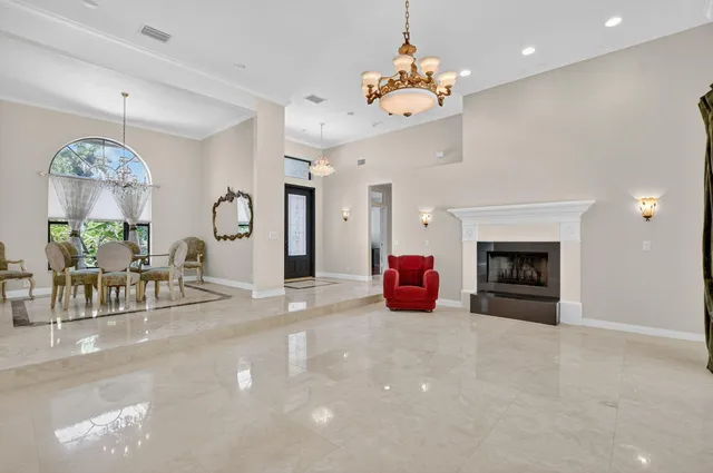 a view of a dining room with furniture a chandelier and wooden floor