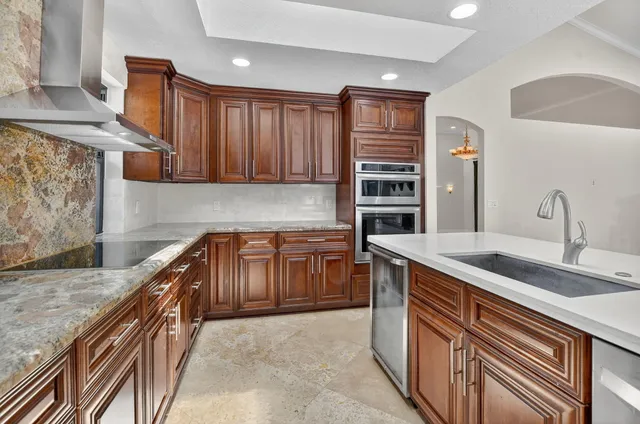 a bathroom with a granite countertop sink a toilet a mirror and shower