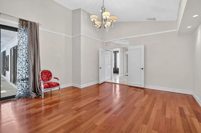 a view of a hallway view with wooden floor and workspace