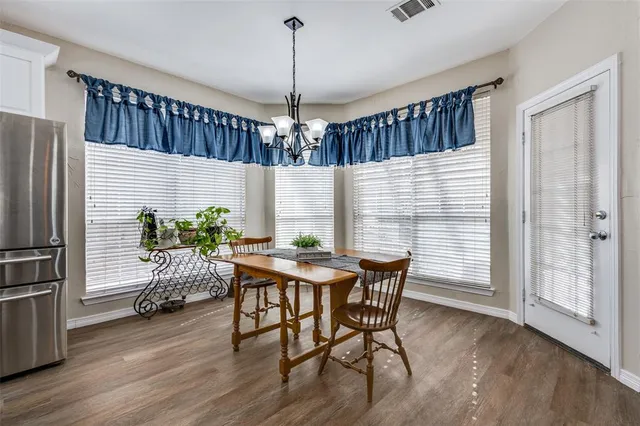 a dining room with furniture window and wooden floor
