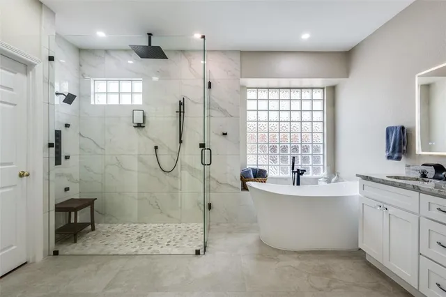 a bathroom with a double vanity sink mirror and shower