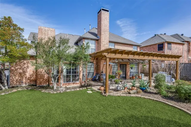 a front view of a house with a garden and plants