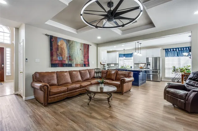 a living room with furniture and kitchen view