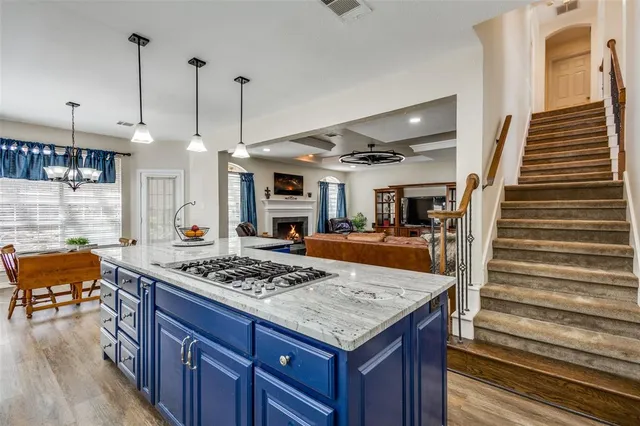 a kitchen with a stove and a wooden floor