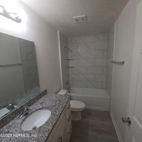 a bathroom with a toilet a sink and a mirror